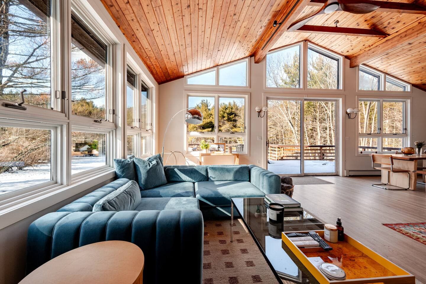 The Cedar Stock Cabin living room with large windows framing the surrounding mountain views