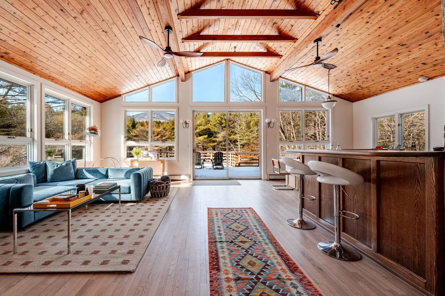 Spacious living room with vaulted cedar ceiling and mountain views at The Cedar Stock Cabin