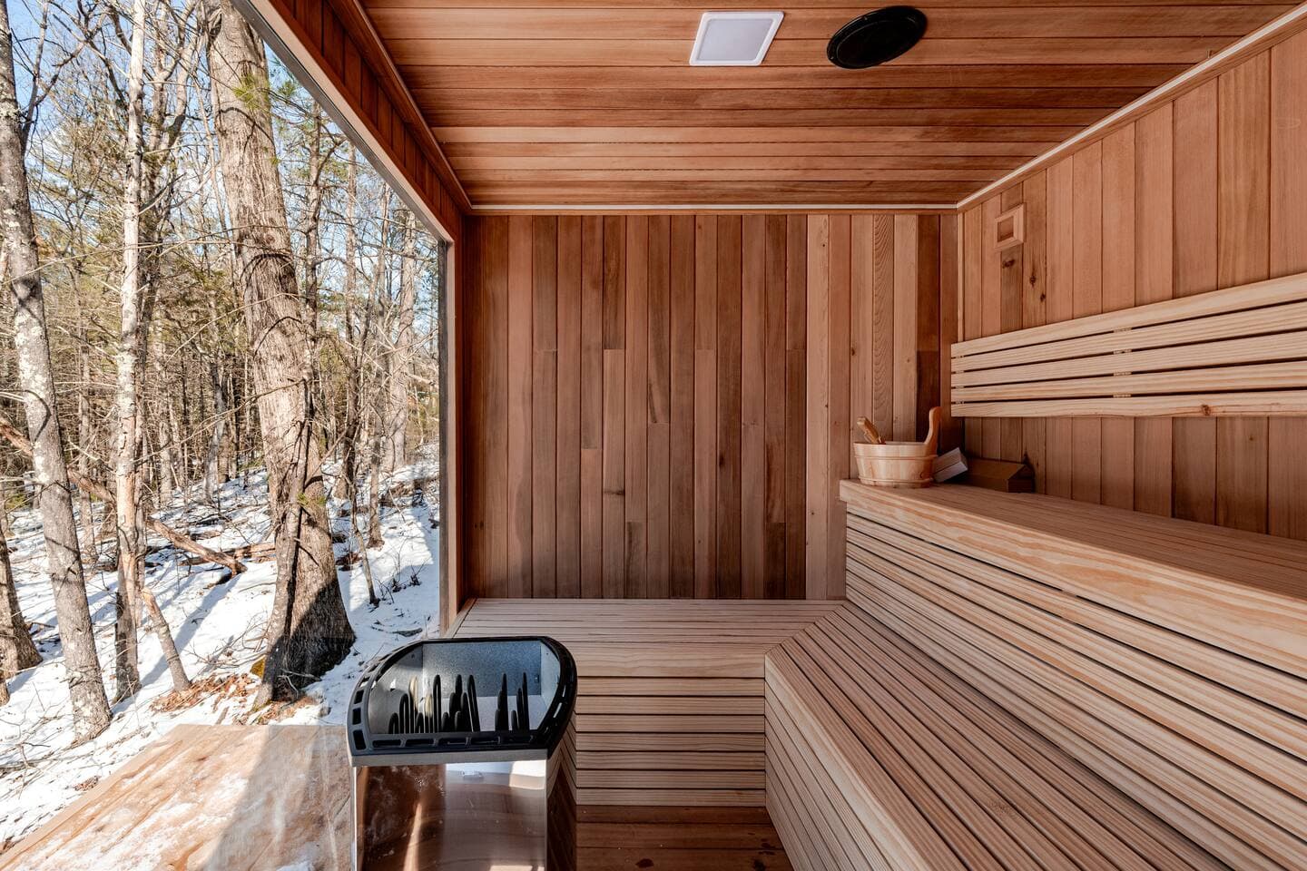 Cedar sauna interior with forest view